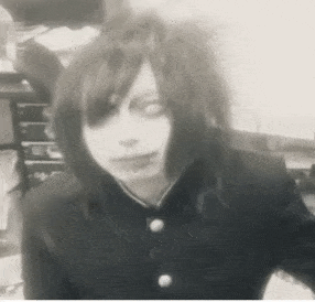 a black and white photo of a person with long hair and piercings