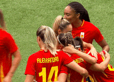 a group of female soccer players are hugging each other and one has the number 10 on her jersey