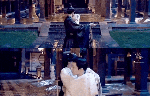a man is carrying a woman in his arms in the rain in a building .