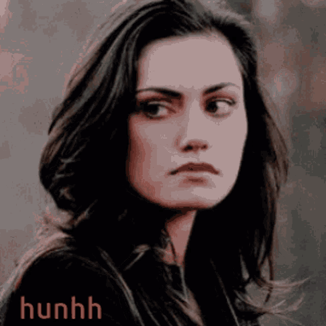 a close up of a woman 's face with the word hunhh written on the bottom