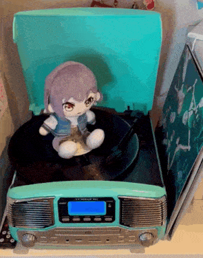 a stuffed animal is sitting on top of a record player that says " t-skiff "