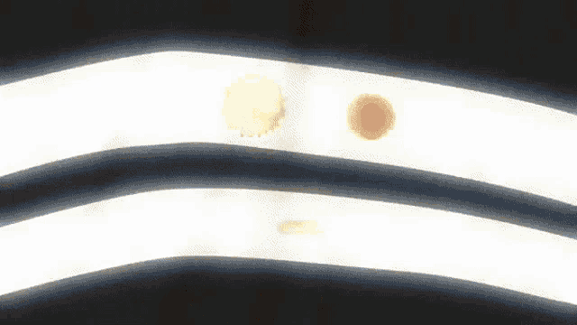a black and white striped background with a yellow circle on the right