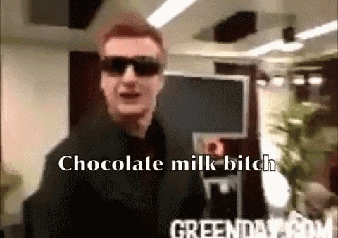 a man wearing sunglasses and a suit says chocolate milk bitch .