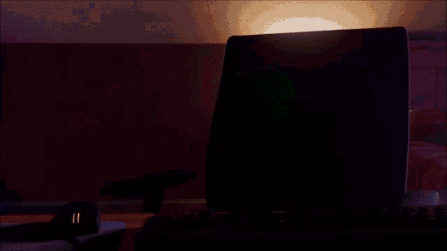 a green frog is sitting at a keyboard with a mouse