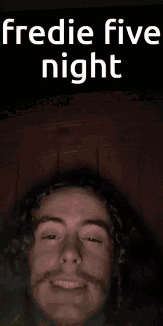 a blurred image of a man 's face with the words fredie five night above him