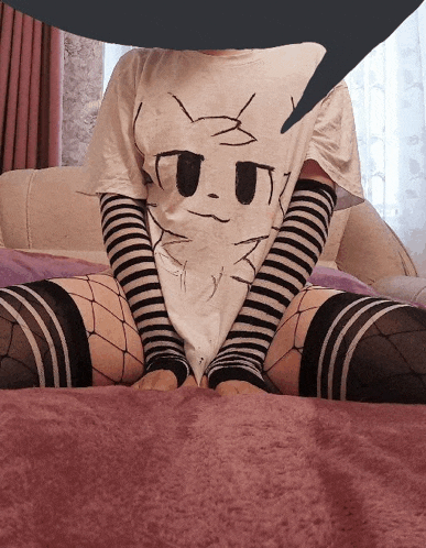 a person wearing a t-shirt with a cat face on it