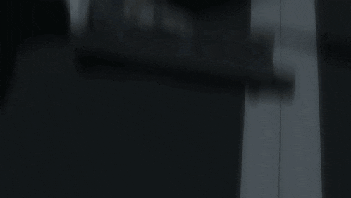 a close up of a man holding a gun with a red light coming out of his eyes