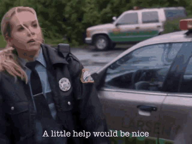 a police officer stands in front of a car that says larsen