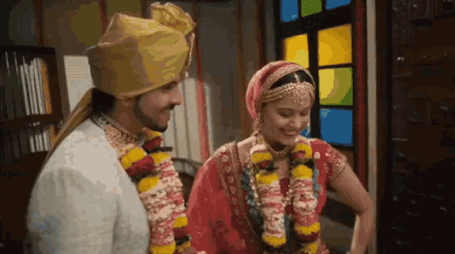 a bride and groom are posing for a picture in front of a window