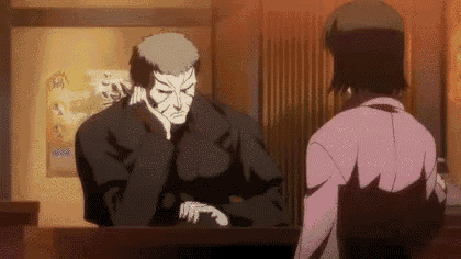 a man and a woman are sitting at a table in a restaurant .