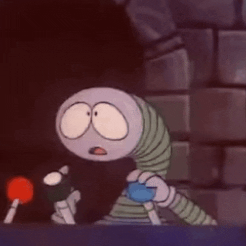 a cartoon character is sitting on a table with a microphone in front of him .