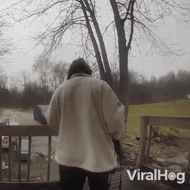 a person standing on a deck with the word viralhog on the bottom right