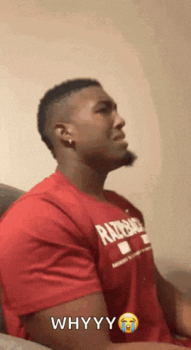 a man is wearing a red shirt that says whyyy