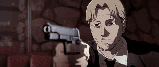 a man in a suit is pointing a gun at the camera