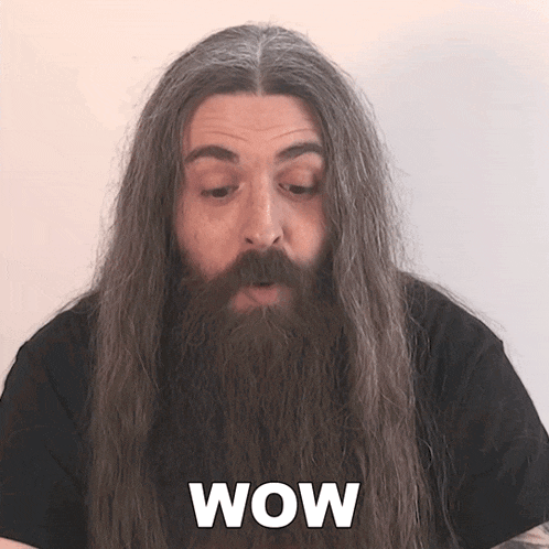 a man with long hair and a beard has the word wow written on his face