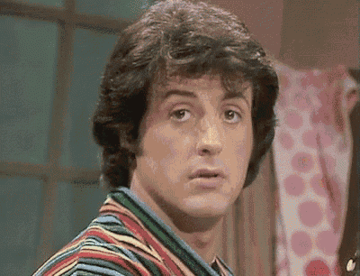 a close up of a man 's face wearing a striped shirt