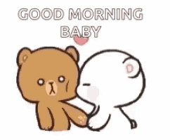 a teddy bear is kissing another teddy bear on the cheek while holding a heart .