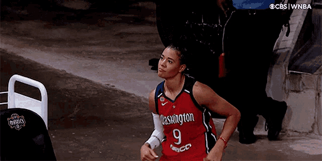 a woman in a washington jersey with the number 9