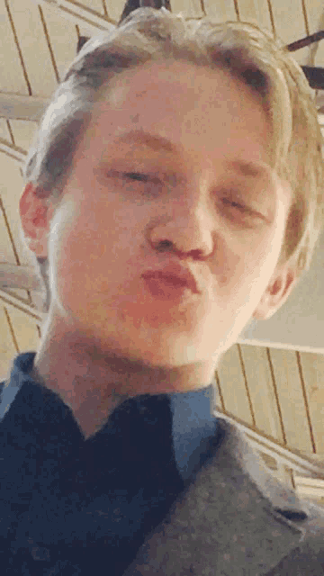 a close up of a man making a funny face with his mouth open