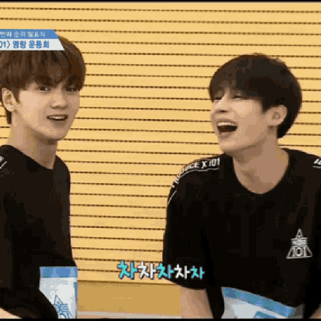 two young men are laughing and one has a shirt that says juice x 101
