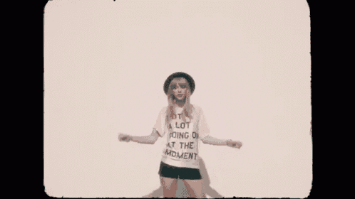 a woman wearing a hat and a t-shirt that says " a lot going on at the moment "