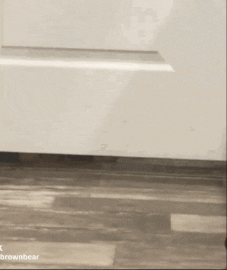 a white door is sitting on a wooden floor next to a white wall .