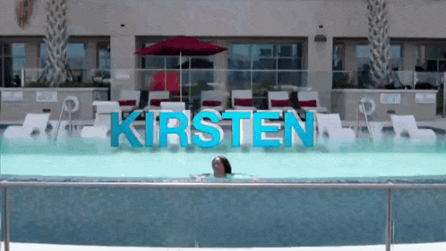 a woman is swimming in a pool with the name kirsten in blue