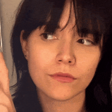 a close up of a woman 's face with her eyes closed