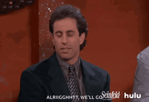 a man in a suit and tie says alriigghtt we 'll go on hulu