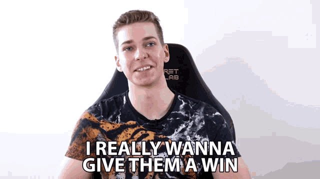 a man sitting in a chair with the words " i really wanna give them a win " above him