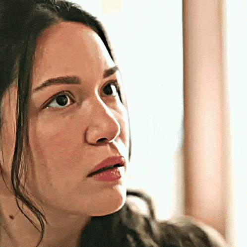 a close up of a woman 's face with her eyes closed