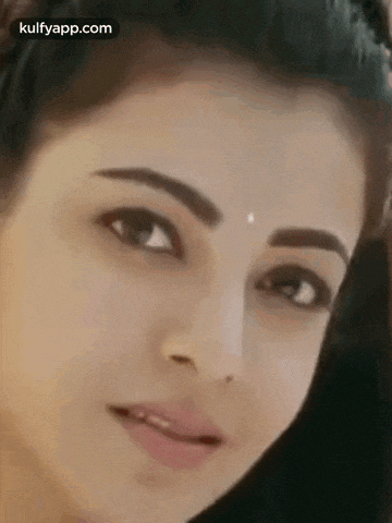 a close up of a woman 's face with a piercing in her nose .