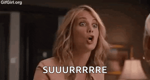 a woman is making a surprised face while talking to a man in a room .