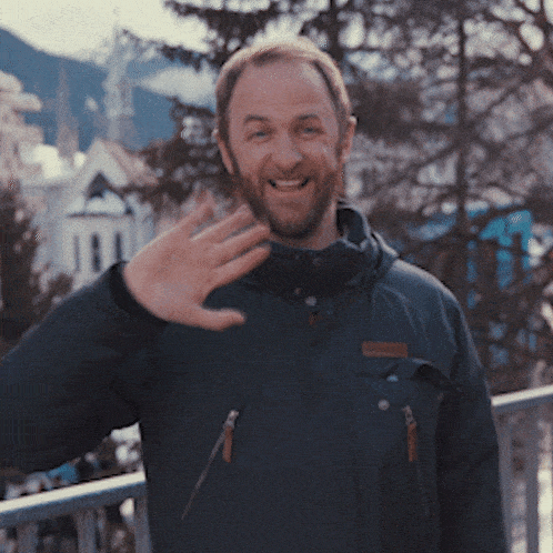 a man with a beard wearing a columbia jacket