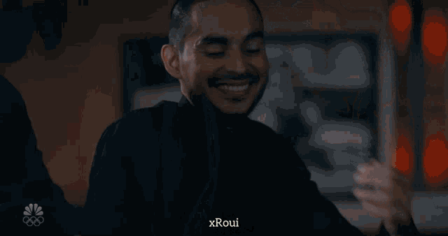 a man in a suit and tie is talking to a woman with xroui written on the bottom