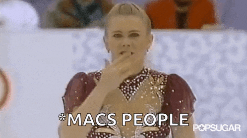 a female figure skater is covering her mouth with her hand and the words macs people are visible behind her .