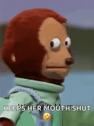 a stuffed monkey says " keeps her mouth shut " with a smiley face