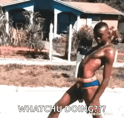 a man in a bikini is walking down a street and says `` whatchu doing '' .
