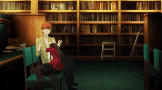a man sits on a chair in front of a bookshelf in a library
