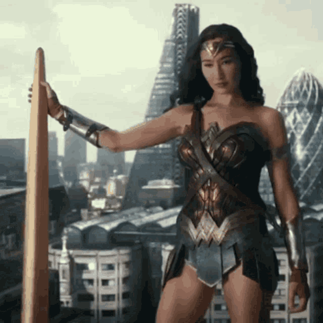 a woman in a wonder woman costume is holding a sword