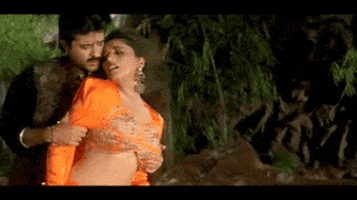 a man is touching a woman 's stomach in a video .