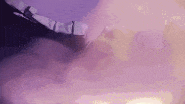 a purple background with mountains and clouds in the background