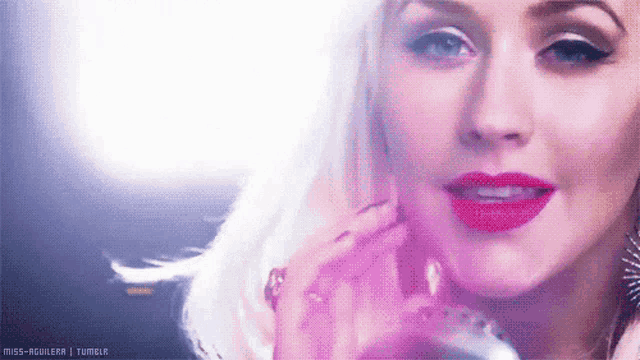 a close up of a woman 's face with the words miss aguilera tumblr written below her