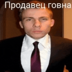 a man in a suit and tie is giving a thumbs up in a foreign language .