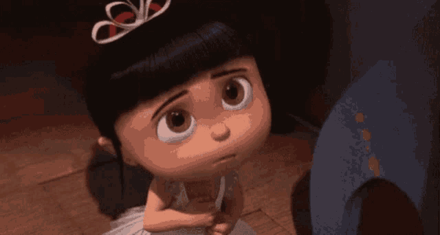a cartoon girl is wearing a tiara and a white dress .