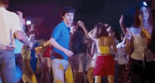 a group of people are dancing together in a club .