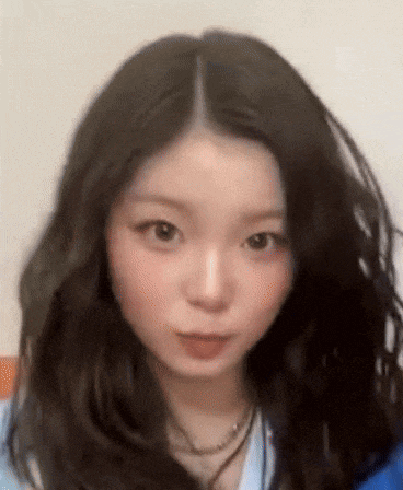 a close up of a woman 's face with long dark hair .