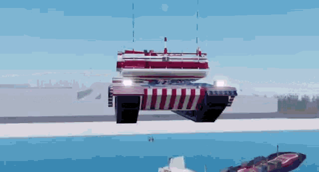 a red , white and blue tank is flying over a body of water in a video game .