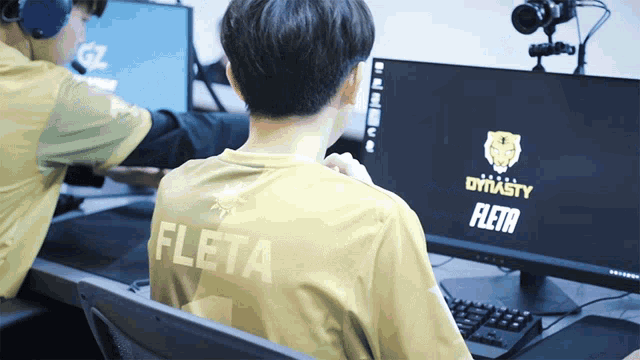 a man wearing a yellow shirt with the word fleta on the back