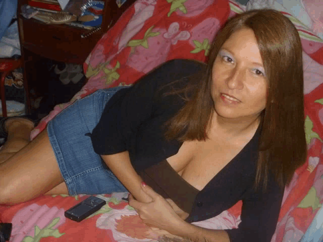 a woman laying on a couch with a cell phone in her hand